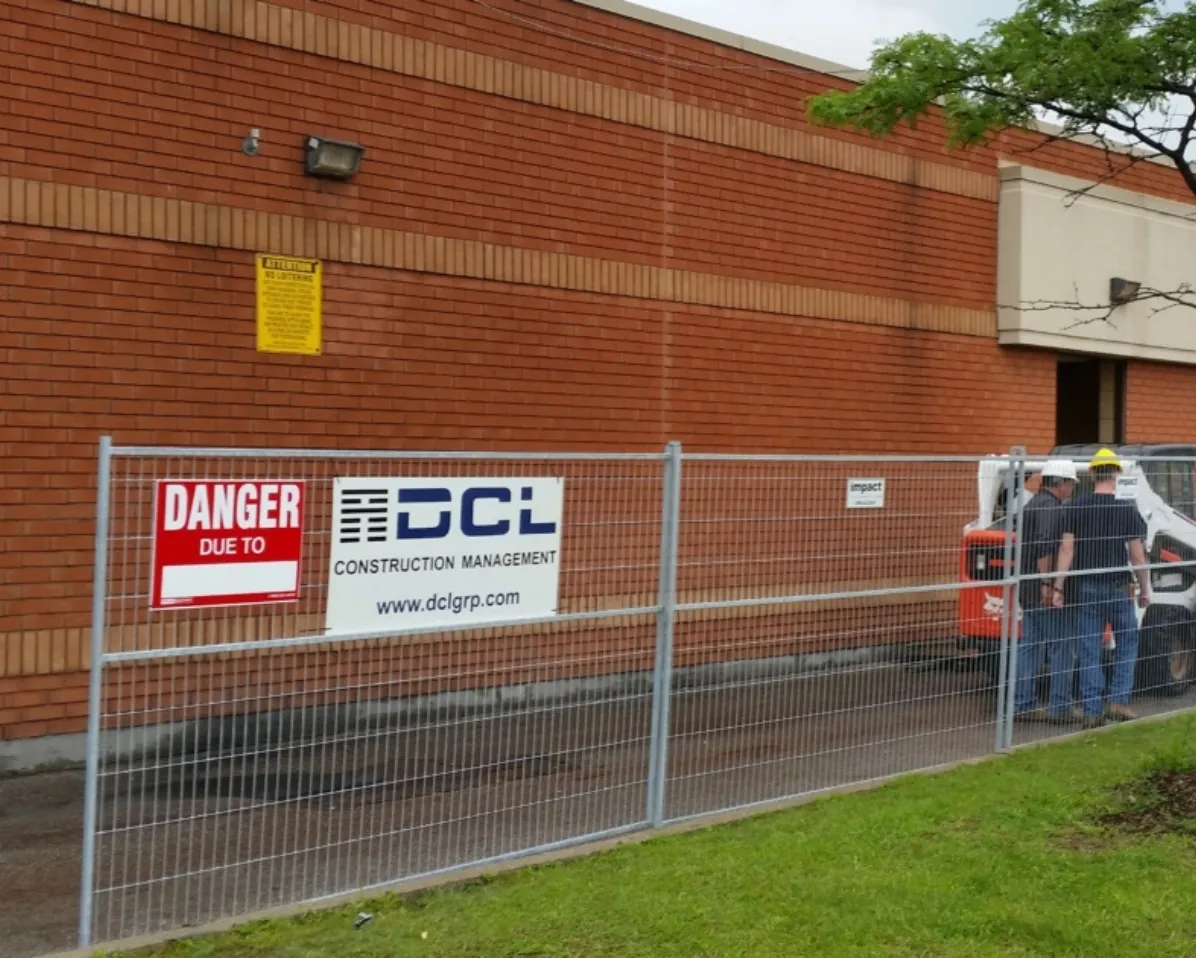 Contractor signage displayed on a brick building facade