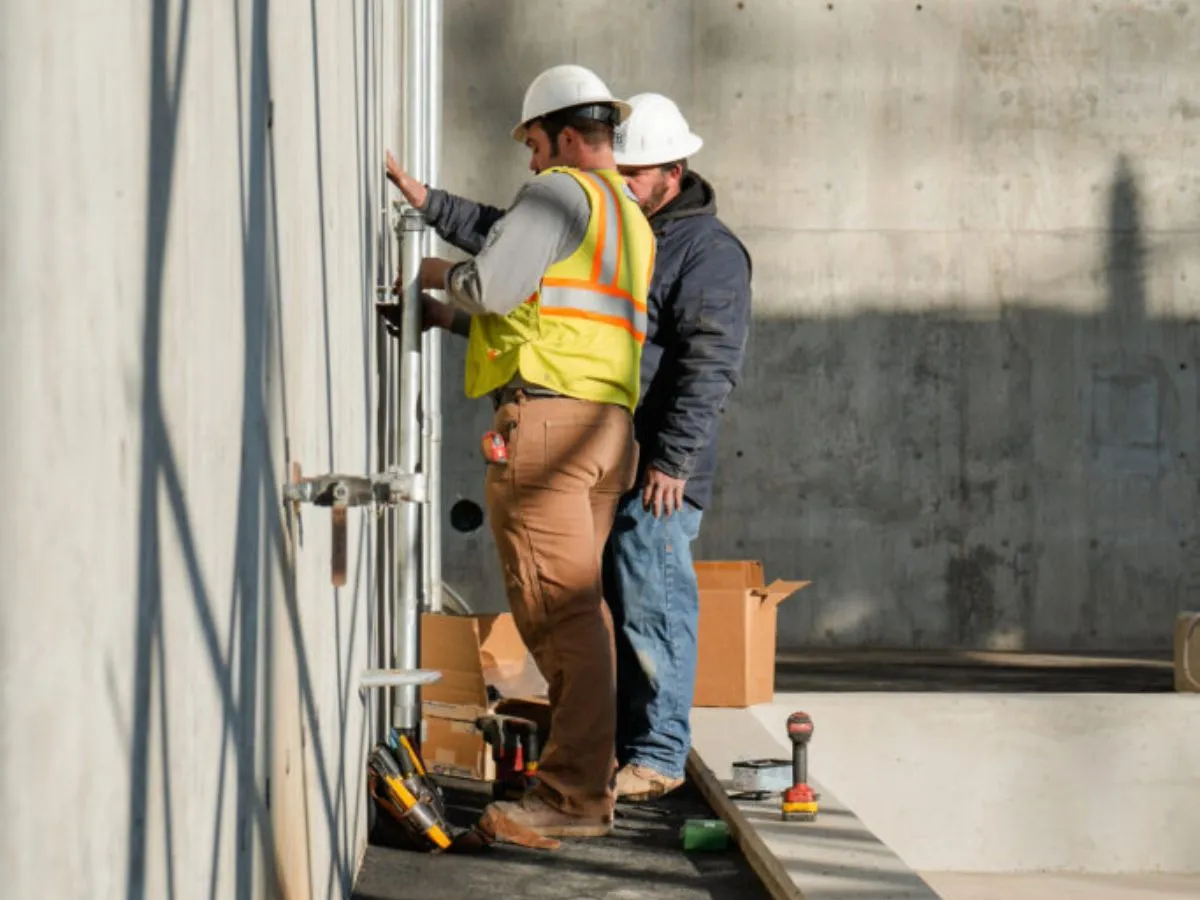 Electricians wiring an interior distribution panel