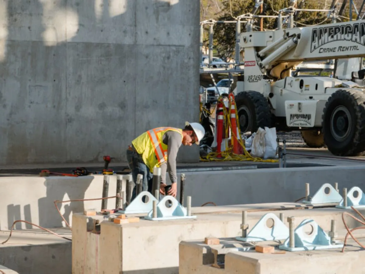 Electrician working at floor level with tools laid out