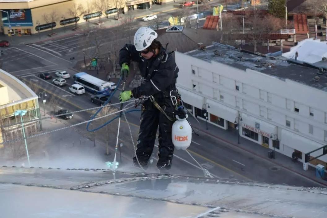 Painter working at height on a building facade