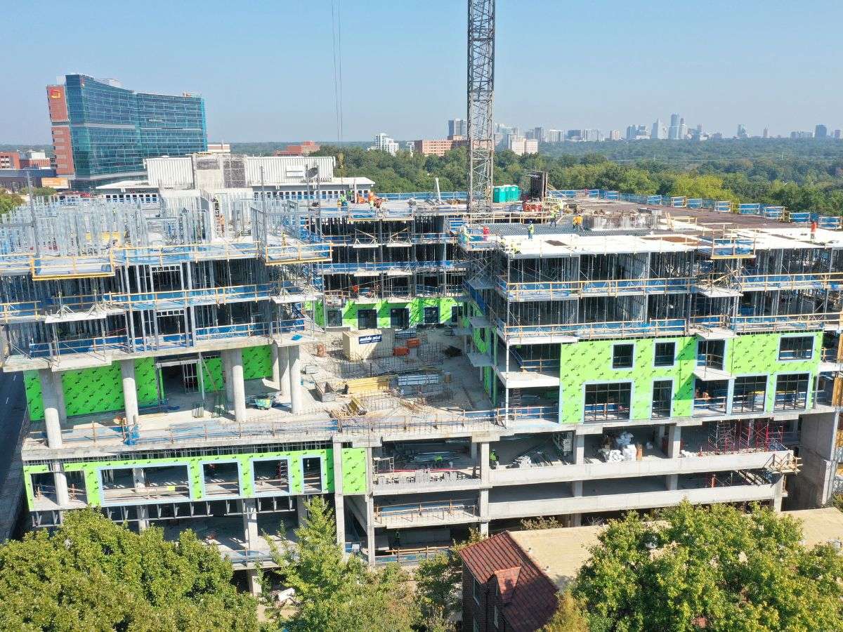Commercial building wrapped in green scaffolding