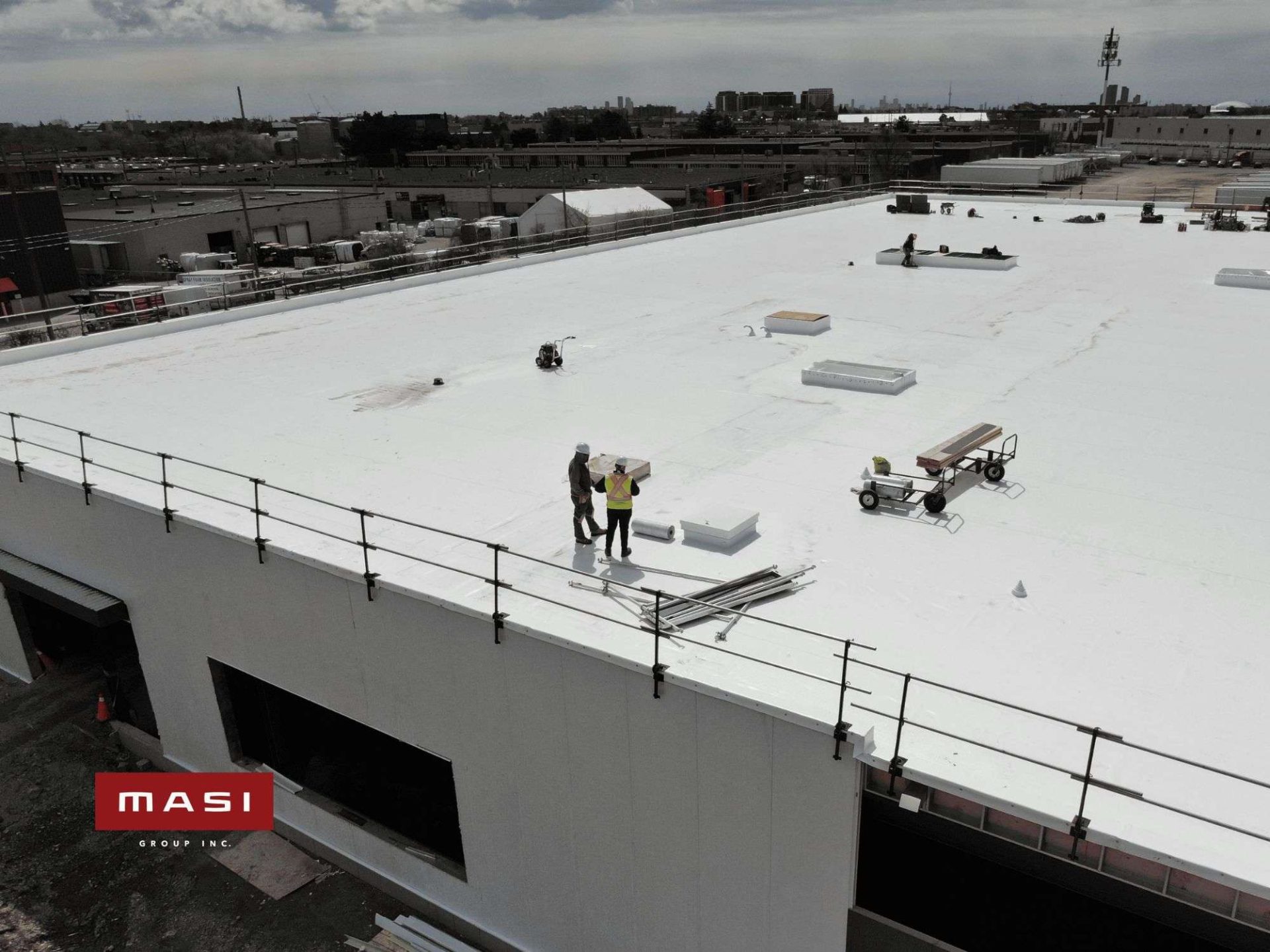 Crew working on a large flat commercial roof