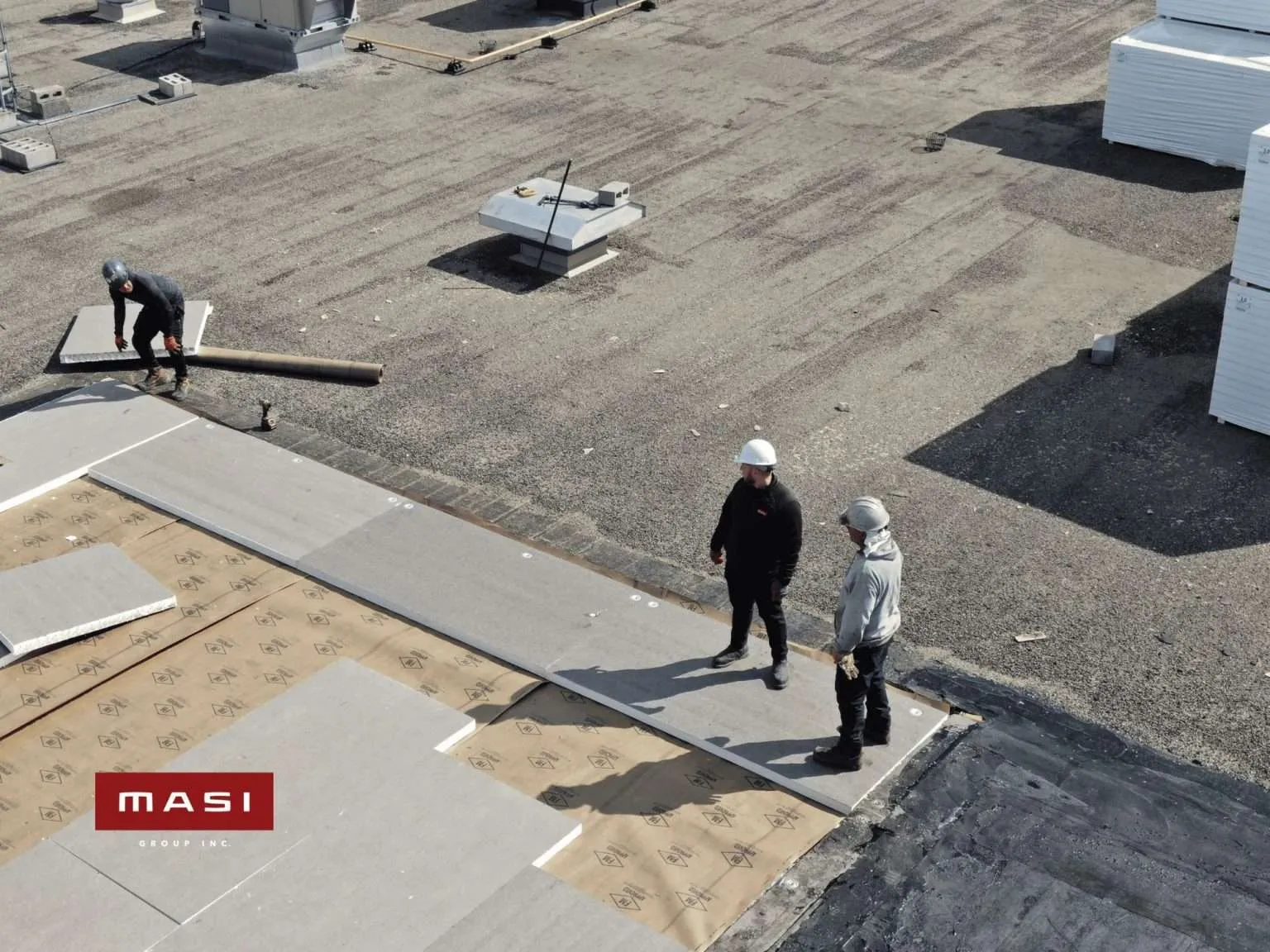 Worker inspecting a completed flat roof