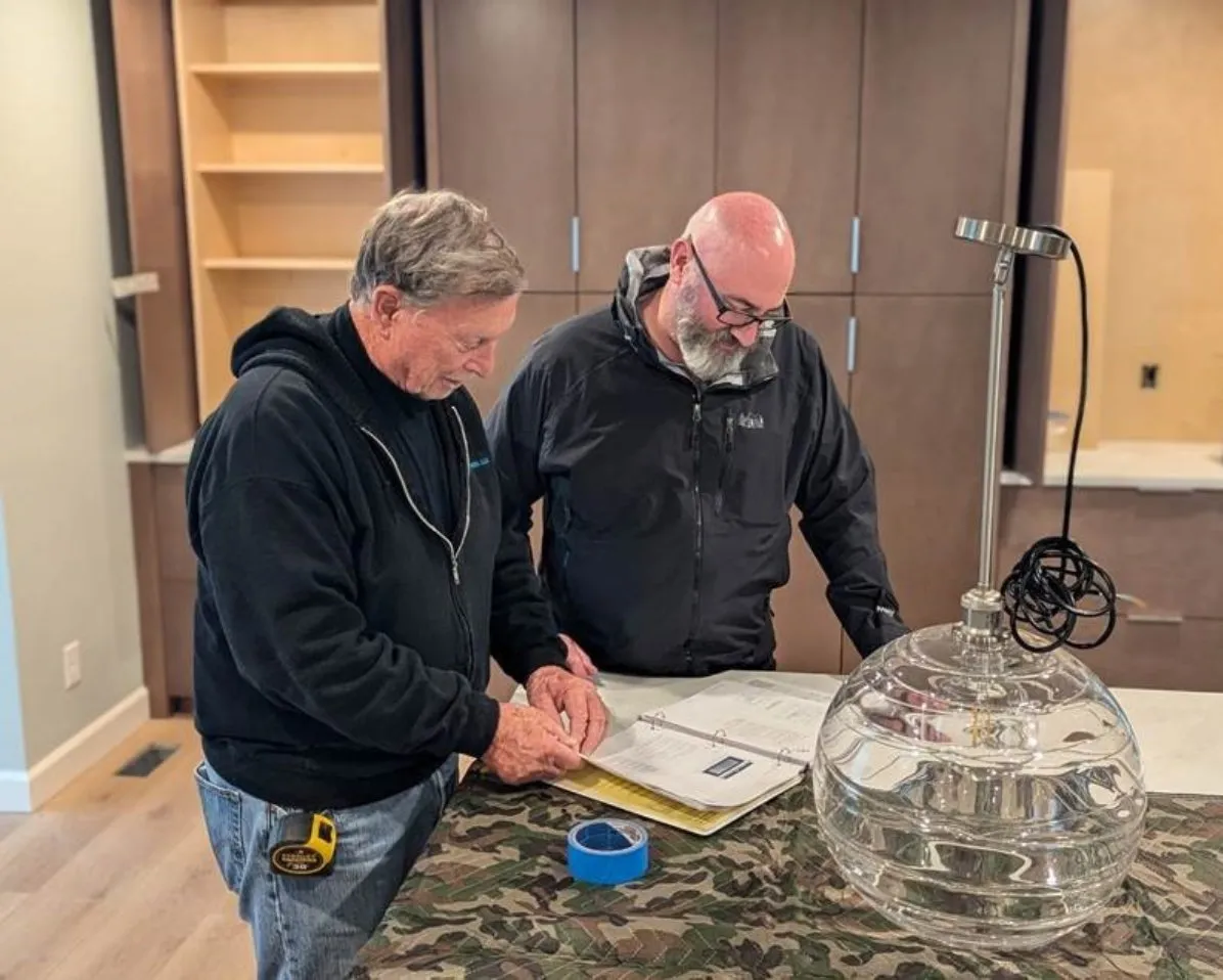 Builders reviewing materials on site
