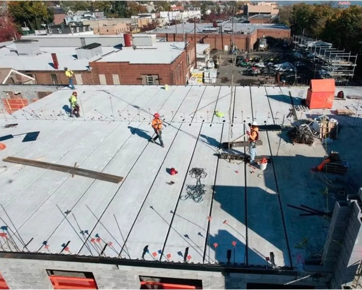 Aerial view of crews working on a large concrete deck