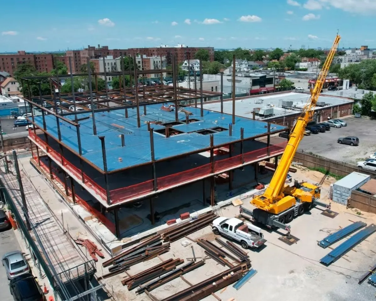 Aerial view of a large building frame with a crane