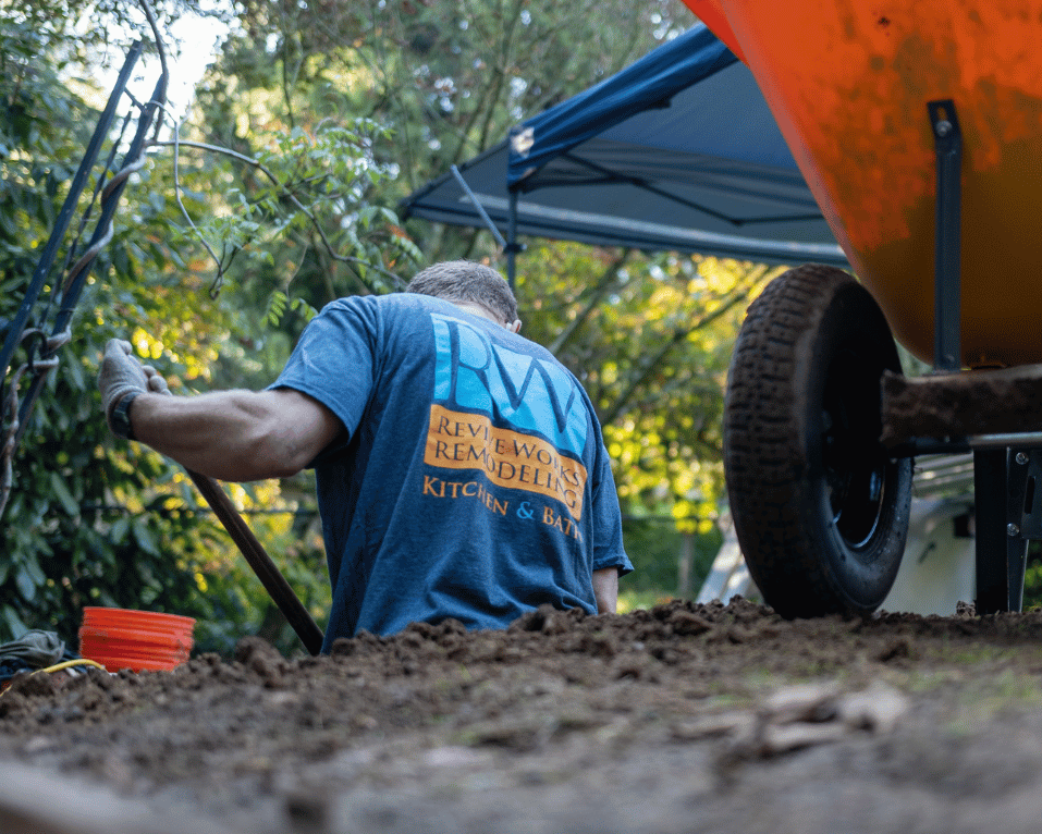Worker operating equipment outside a property