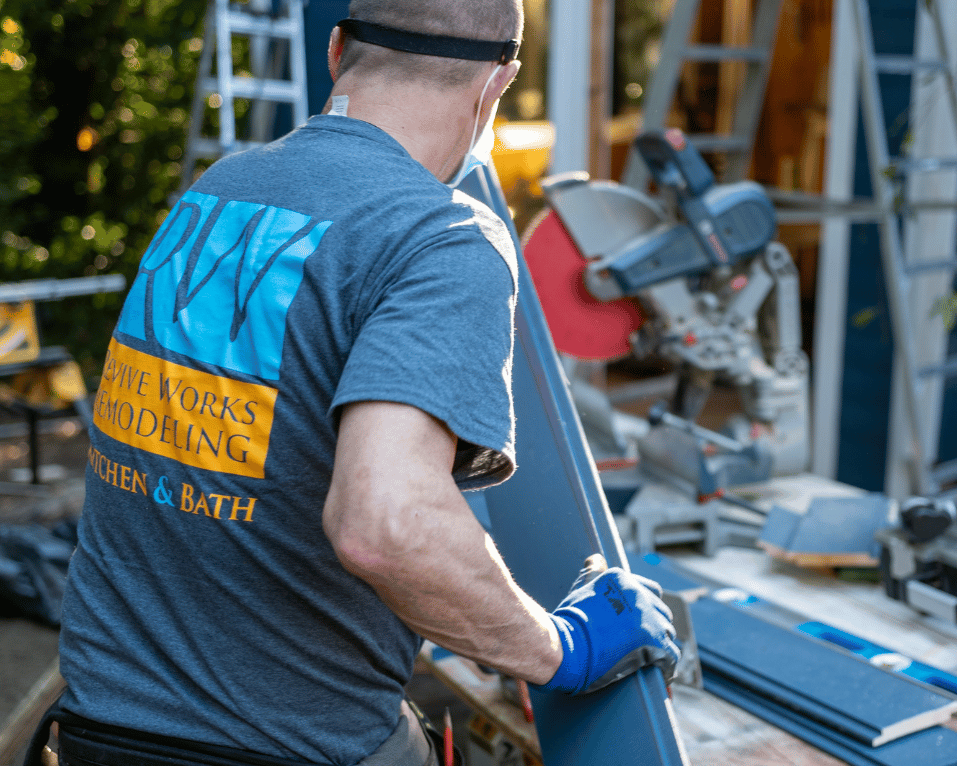 Tradesman fitting plumbing during a bathroom remodel