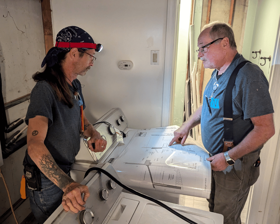 Two tradesmen working together on a bathroom renovation