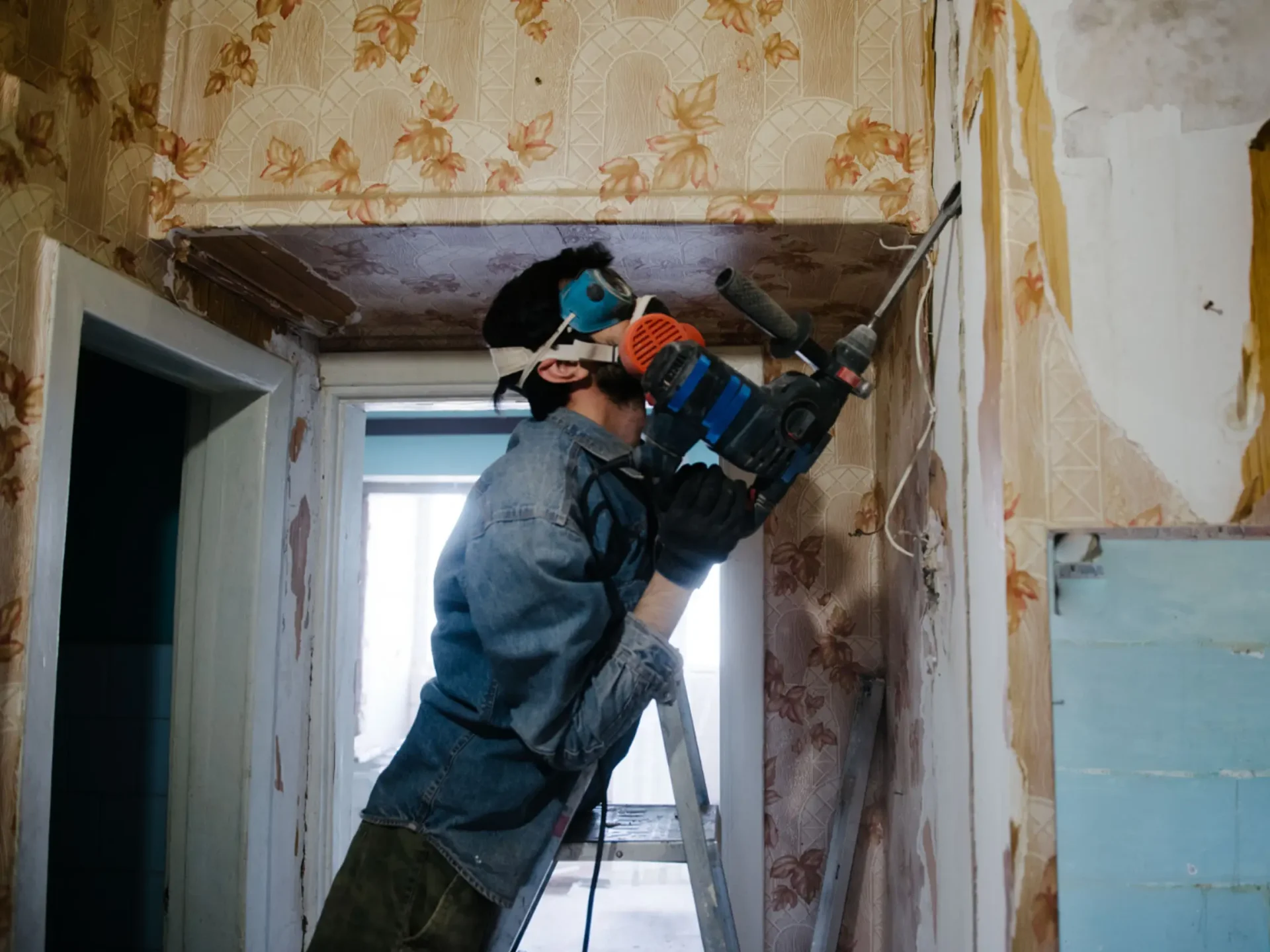 Tradesman working in a narrow interior space
