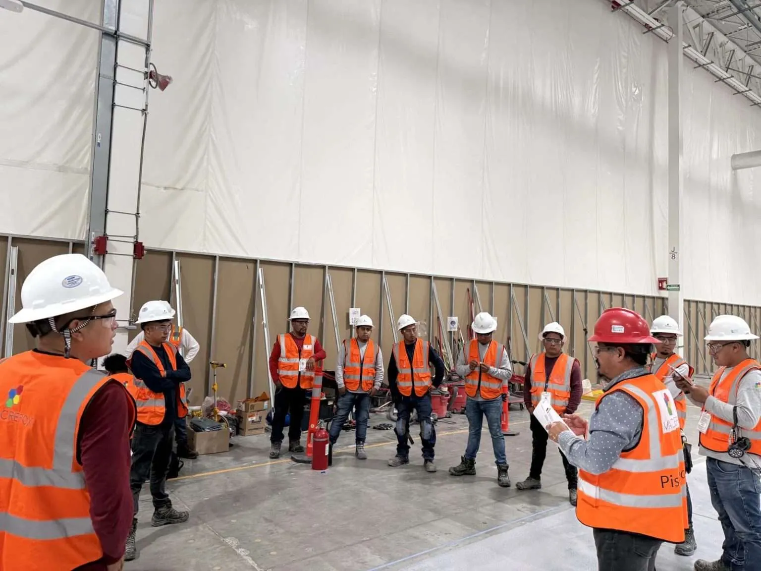 Site team in hi-vis inside a warehouse