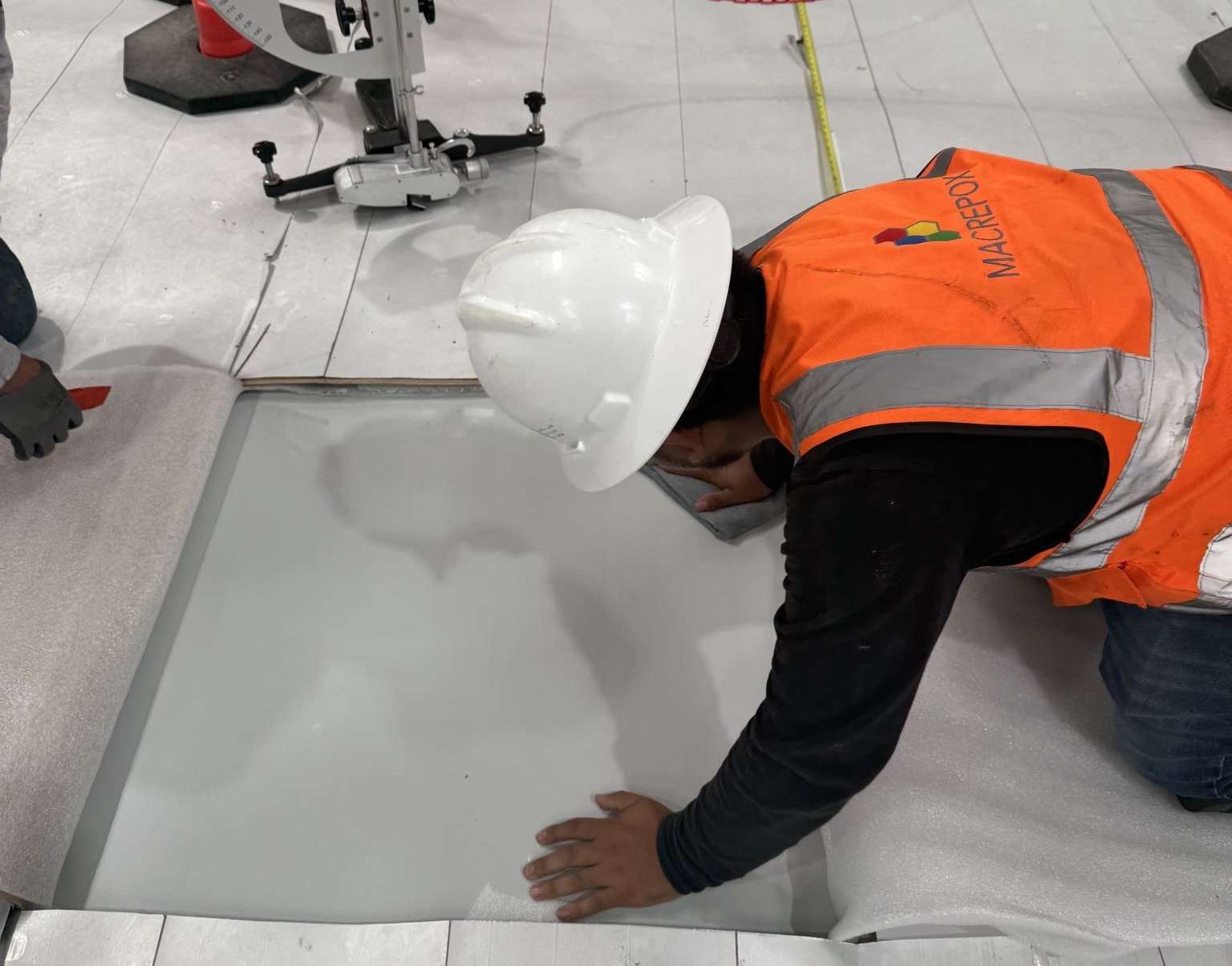 Close-up of a worker applying floor coating