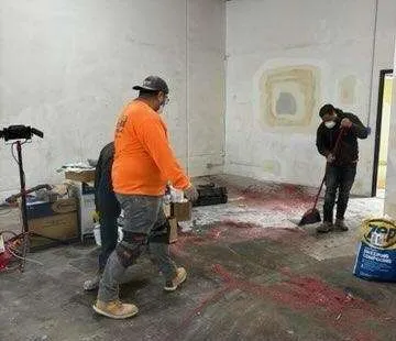 Applicator spreading an industrial floor coating