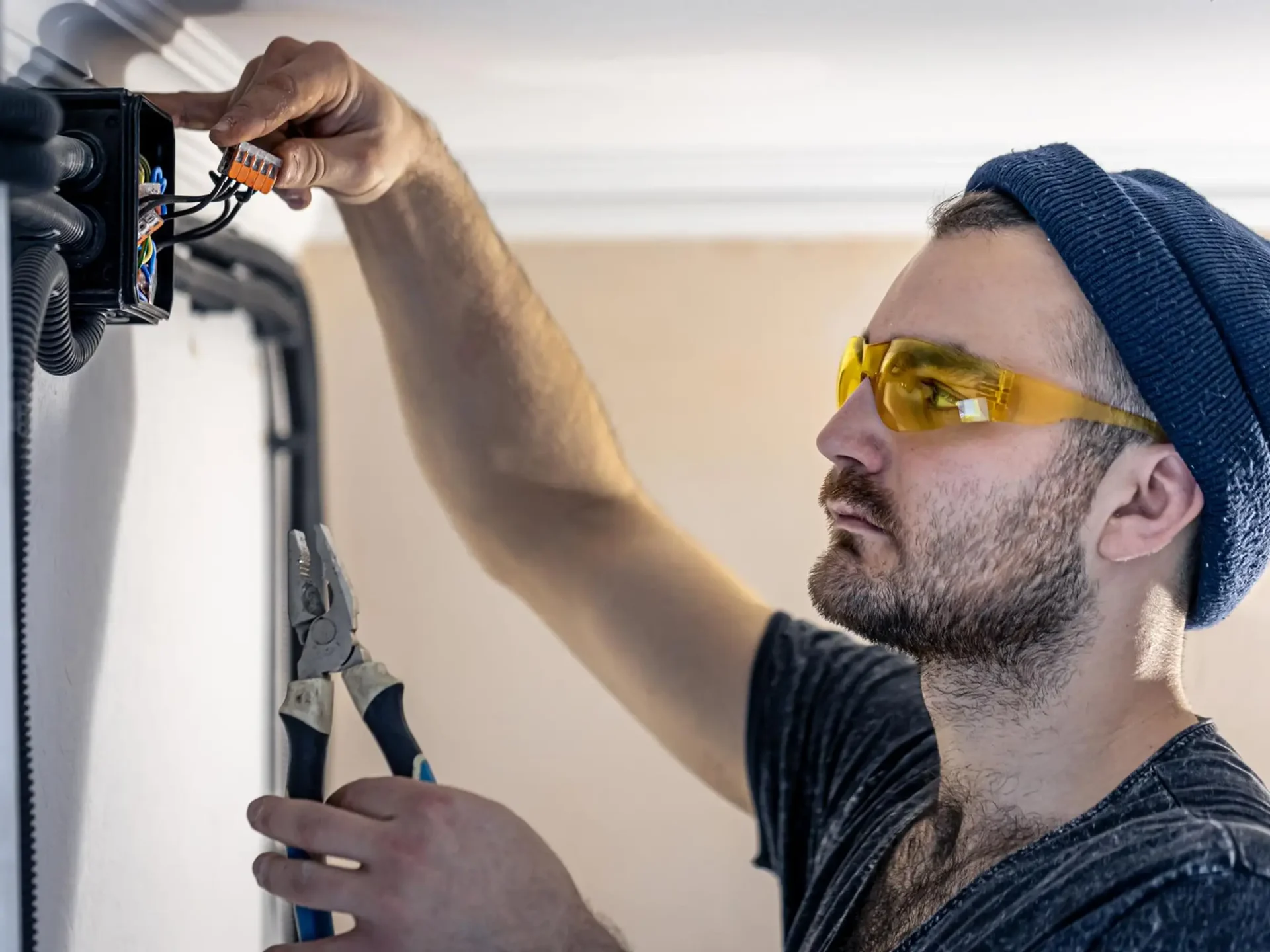 Technician in safety glasses carrying out an installation